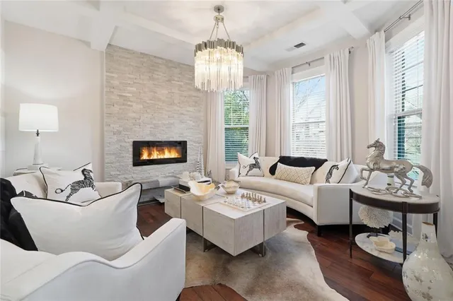 a view of a dining room with furniture a chandelier and wooden floor