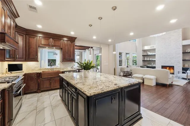 a kitchen with granite countertop a sink and a stove
