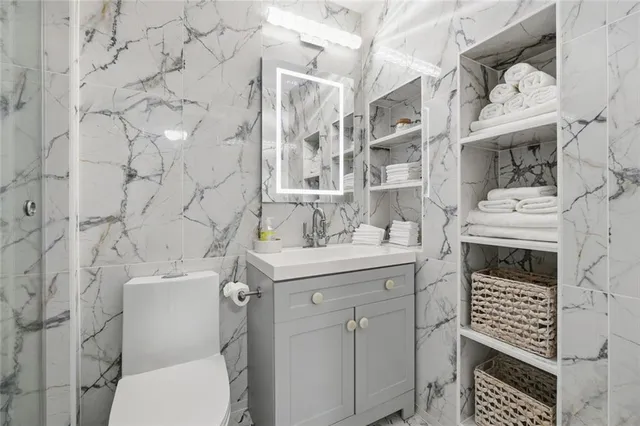 a bedroom with a bed and a ceiling fan