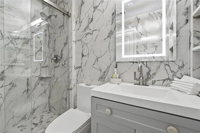 a bathroom with a tub sink and mirror
