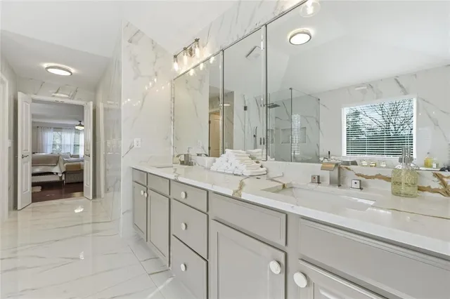 a bathroom with a sink double vanity and a mirror