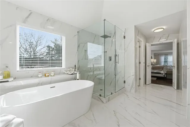 a bathroom with a sink a toilet a mirror and shower