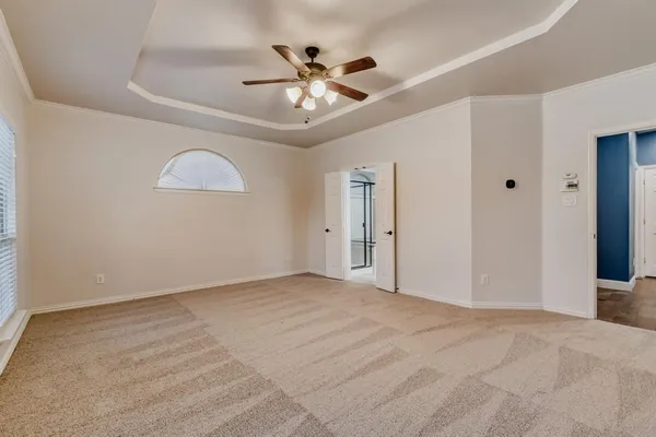 a view of an empty room with a ceiling fan