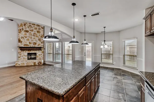 a kitchen with stainless steel appliances granite countertop a kitchen island a stove and a sink