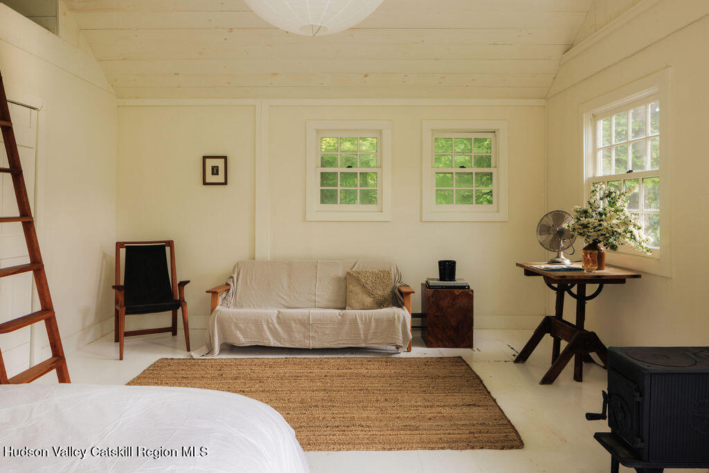 577 Jefferson Hill Road Nassau, NY 12123 - Photo 22 of 33 a bedroom with a bed and wooden floor