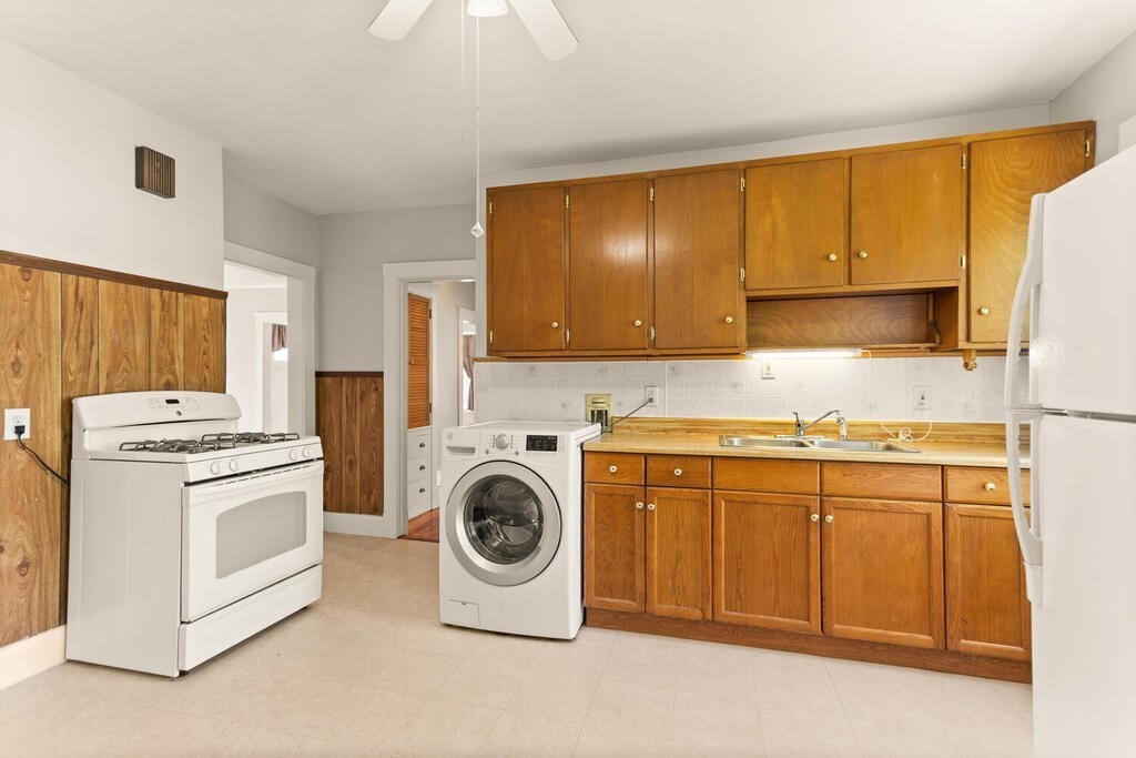 14-16 Harding Road Norwood, MA 02062 - Photo 10 of 31 a kitchen with a stove top oven sink and cabinets