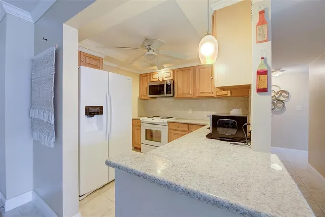 a kitchen with cabinets appliances and a sink