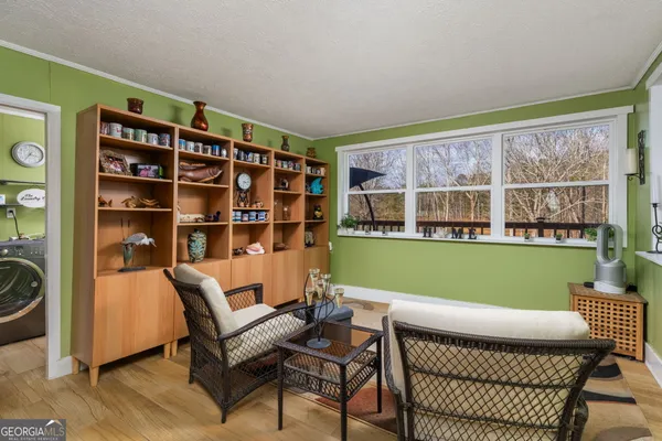 a living room with furniture and a floor to ceiling window