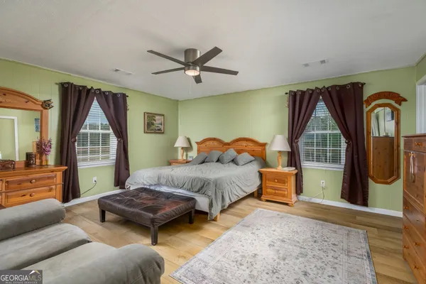 a living room with a bed furniture and a window