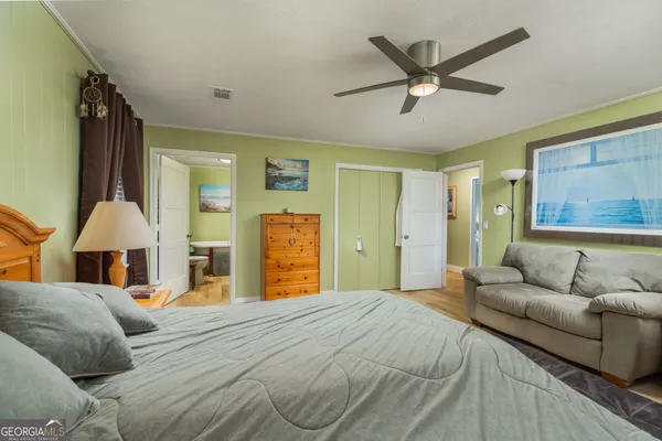 a bedroom with a bed and ceiling fan