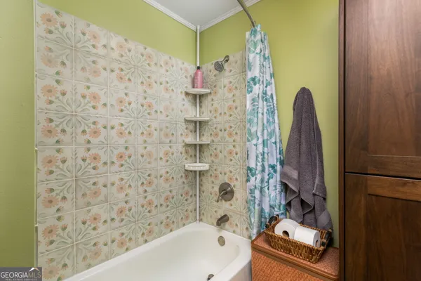 a bathroom with a bathtub and shower