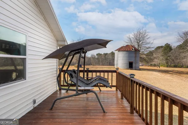 a view of a yard with wooden fence