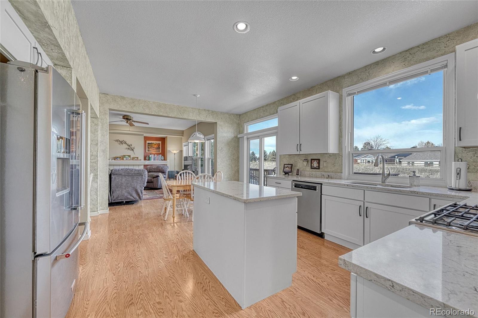 9247 Sugarstone Circle Highlands Ranch, CO 80130 - Photo 12 of 48 a kitchen with sink refrigerator and cabinets