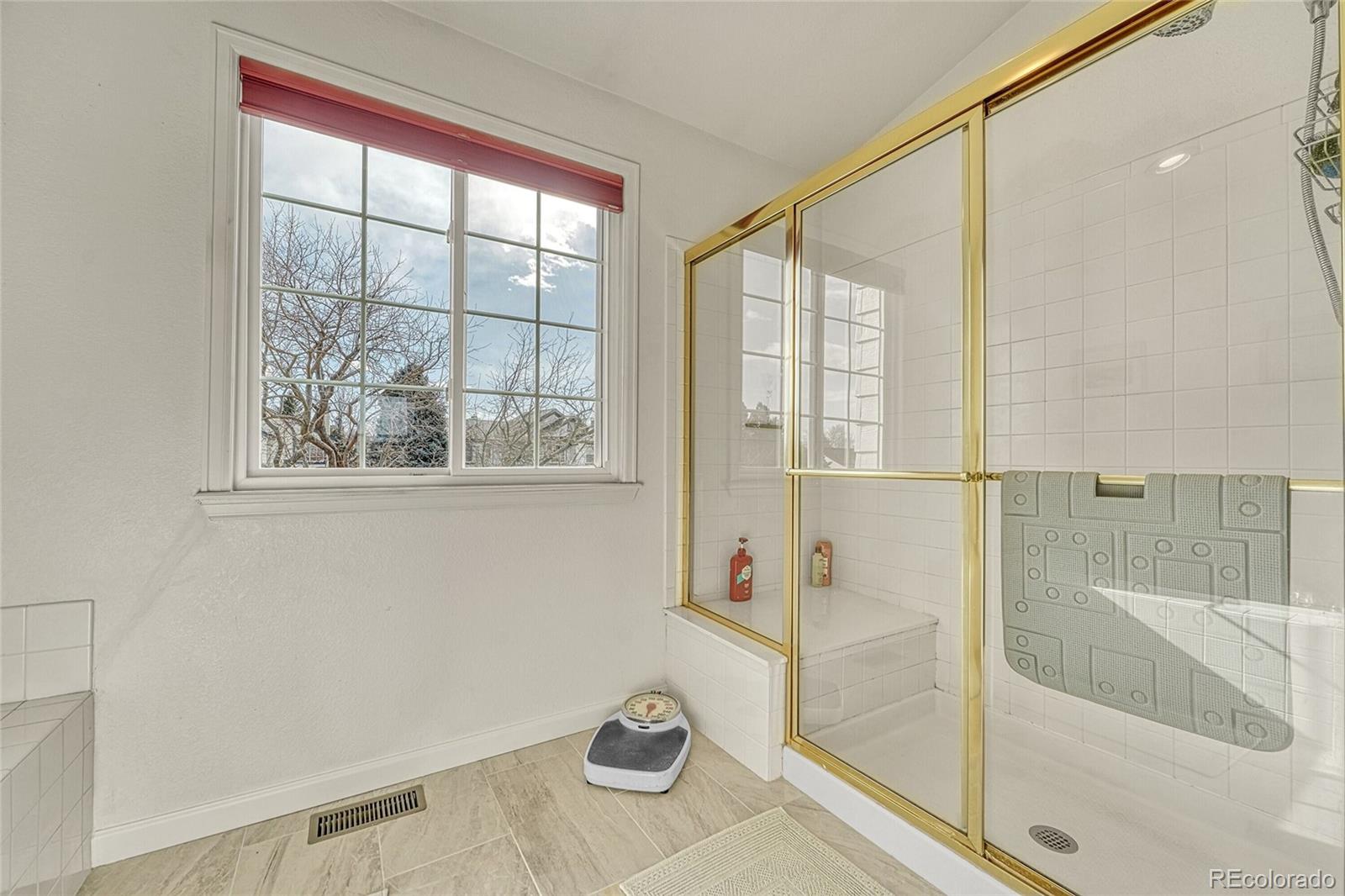 9247 Sugarstone Circle Highlands Ranch, CO 80130 - Photo 21 of 48 a bathroom with a tub and window