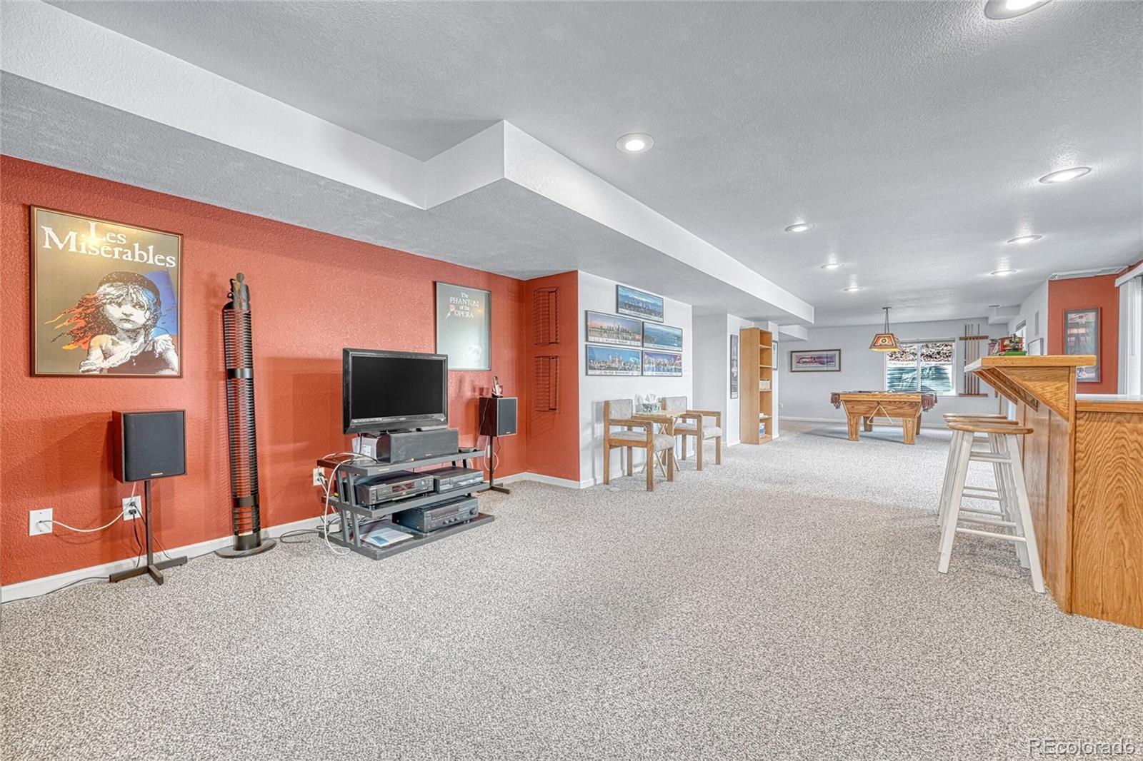 9247 Sugarstone Circle Highlands Ranch, CO 80130 - Photo 28 of 48 a view of a livingroom with furniture and a flat screen tv