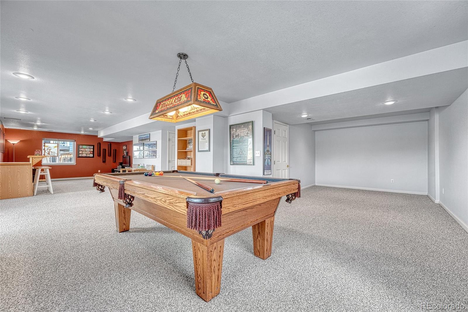 9247 Sugarstone Circle Highlands Ranch, CO 80130 - Photo 29 of 48 a room with a table chairs and a chandelier