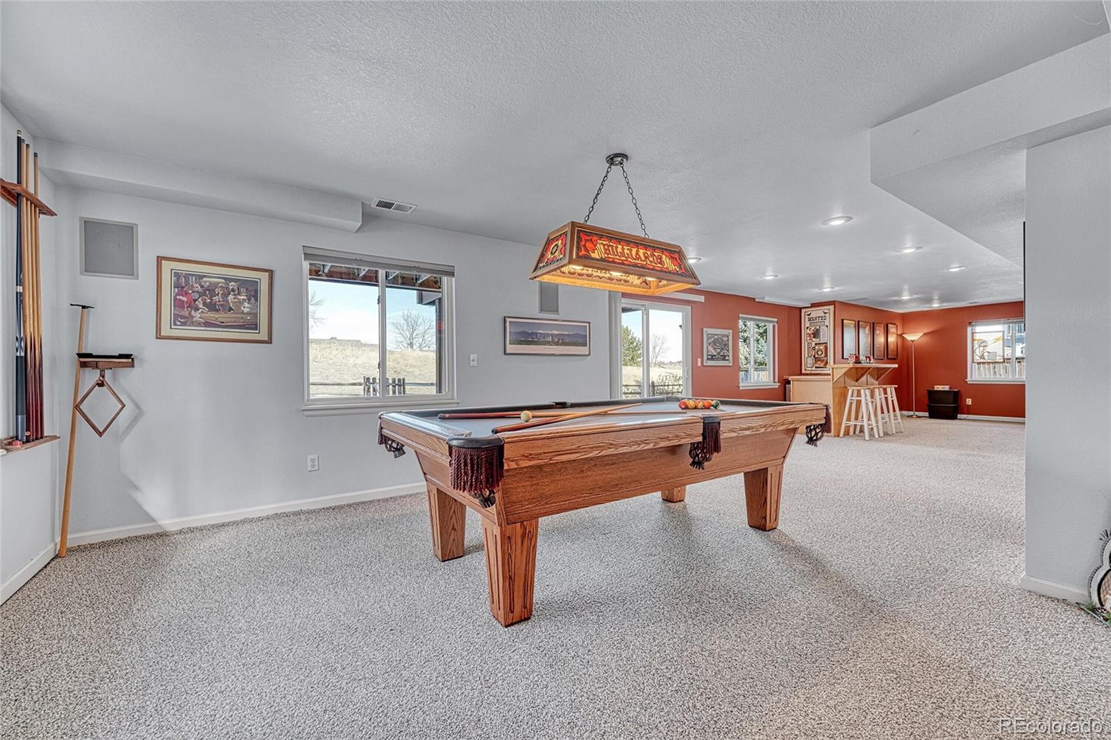 9247 Sugarstone Circle Highlands Ranch, CO 80130 - Photo 30 of 48 a room with lots of furniture and windows