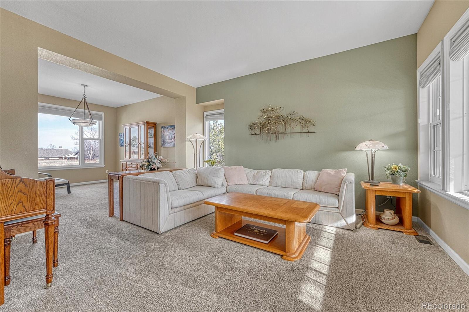 9247 Sugarstone Circle Highlands Ranch, CO 80130 - Photo 4 of 48 a living room with furniture and a large window