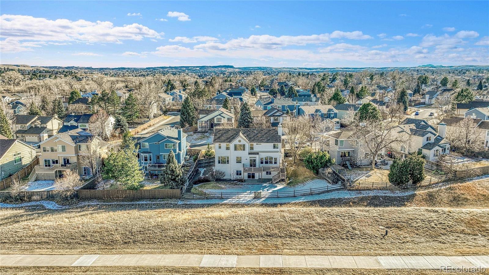 9247 Sugarstone Circle Highlands Ranch, CO 80130 - Photo 43 of 48 an aerial view of residential houses with outdoor space and trees