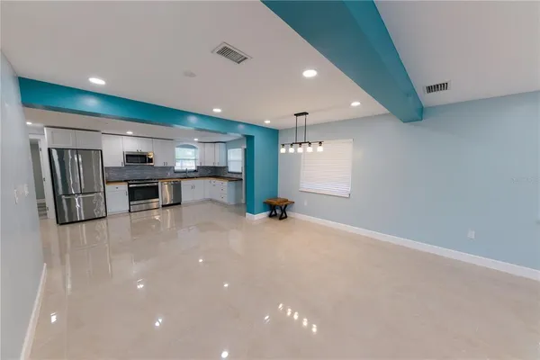 a view of kitchen with furniture and refrigerator