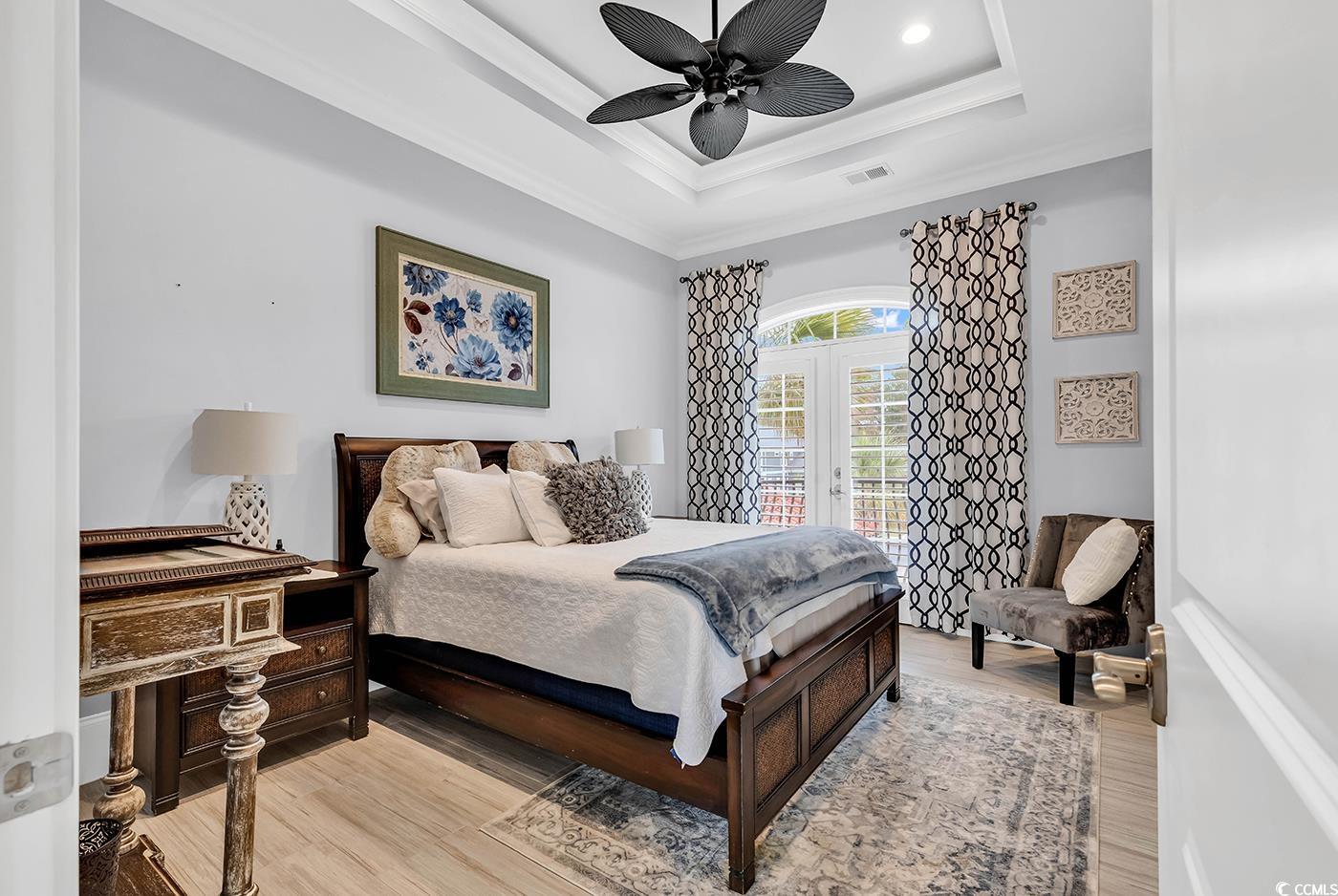 423 Chamberlin Road Myrtle Beach, SC 29588 - Photo 23 of 40 Bedroom featuring ceiling fan, a tray ceiling, cro