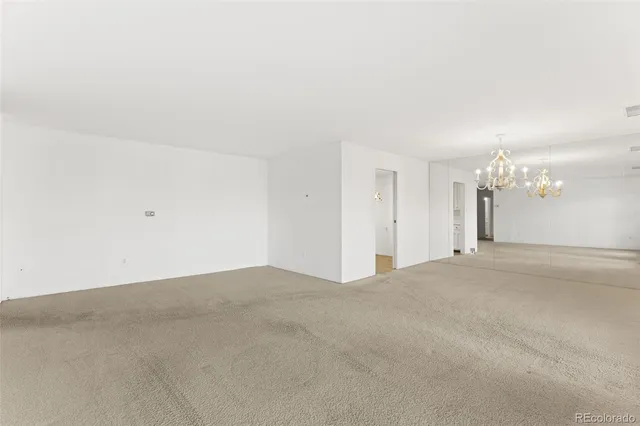a kitchen with white cabinets and wooden floors