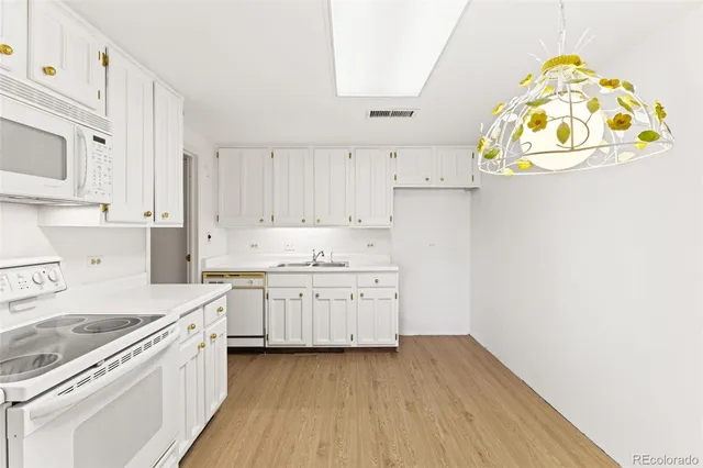 a white stove top oven sitting inside of a kitchen