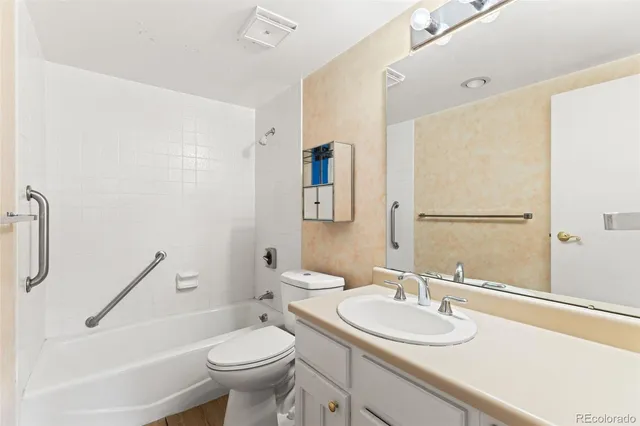 a bathroom with a sink toilet and a mirror