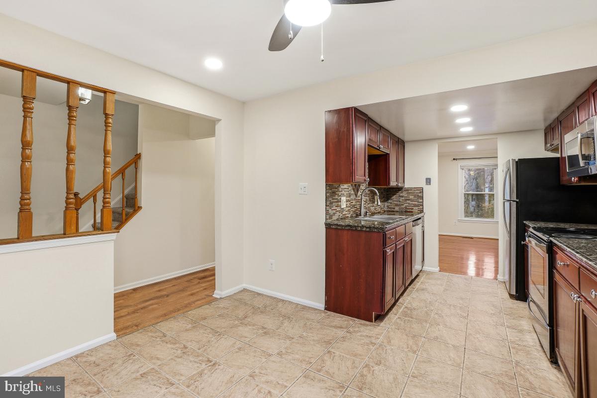 9040 Armendown Drive Springfield, VA 22152 - Photo 13 of 30 a kitchen with stainless steel appliances granite countertop a refrigerator and a stove top oven