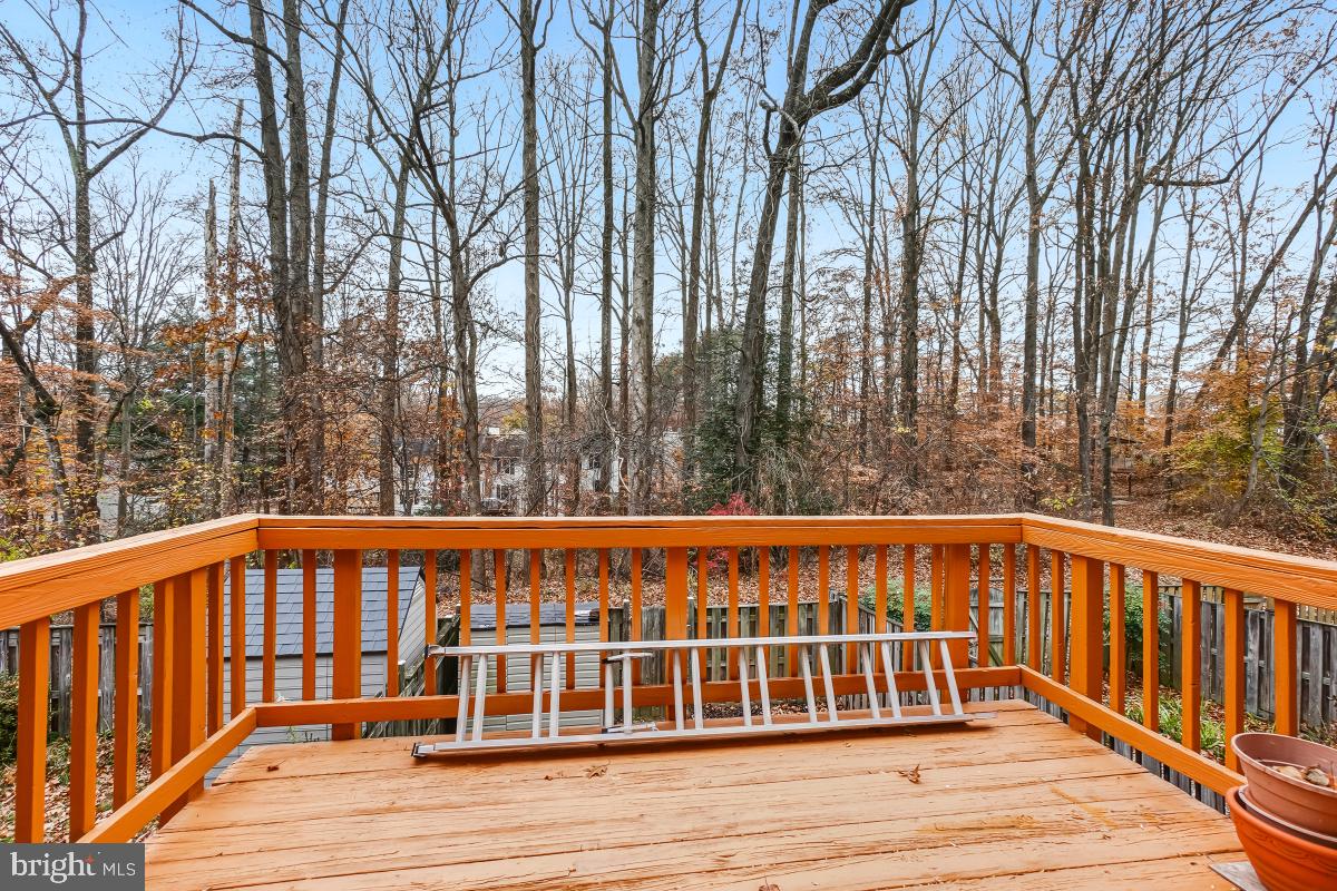 9040 Armendown Drive Springfield, VA 22152 - Photo 14 of 30 a view of a wooden balcony with large trees