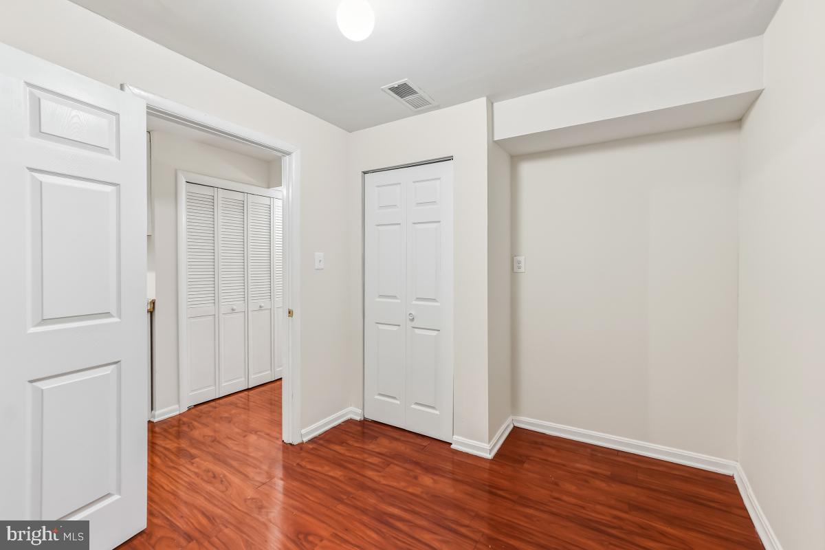 9040 Armendown Drive Springfield, VA 22152 - Photo 22 of 30 a view of an empty room with wooden floor and closet
