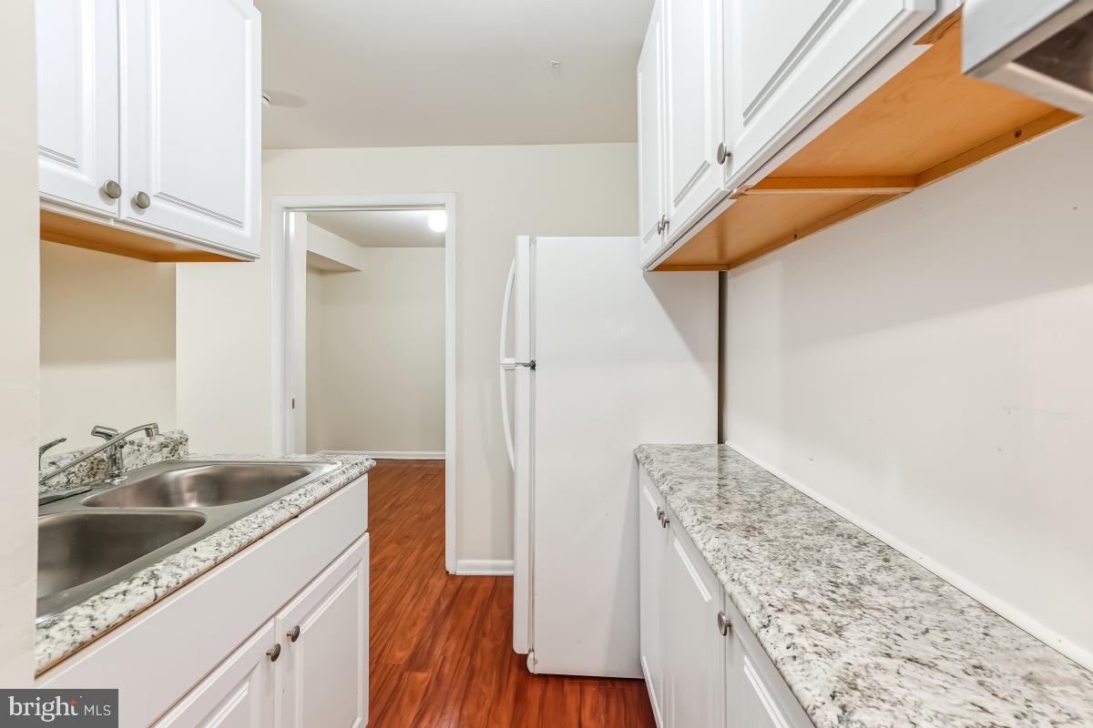 9040 Armendown Drive Springfield, VA 22152 - Photo 25 of 30 a bathroom with a granite countertop sink a vanity and shower