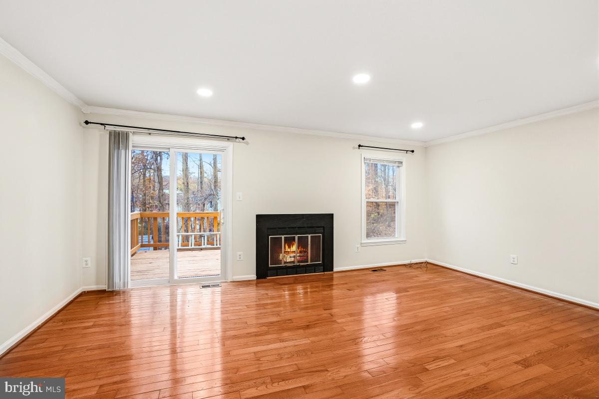9040 Armendown Drive Springfield, VA 22152 - Photo 6 of 30 a view of an empty room with glass door and wooden floor