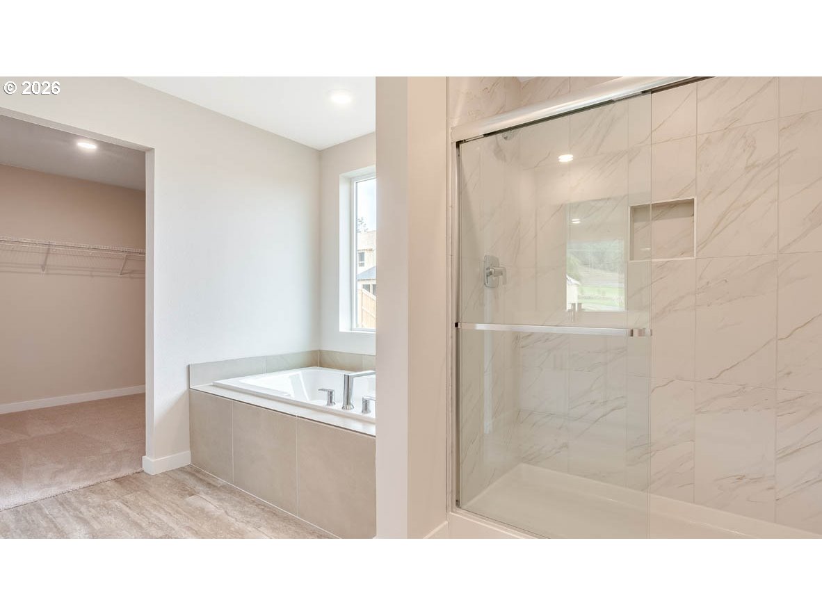 9194 Southeast Azalea Street Happy Valley, OR 97086 - Photo 28 of 32 a bathroom with a tub shower sink and mirror