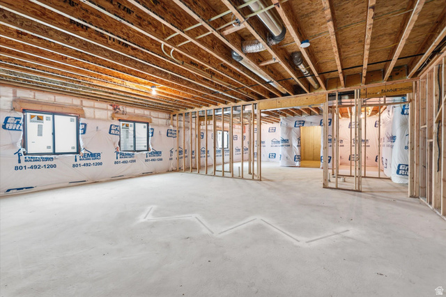 134 South Chamberlain Street Mapleton, UT 84664 - Photo 30 of 40 Unfinished basement featuring exposed wood joists, framed interior walls, concrete flooring, and multiple window openings