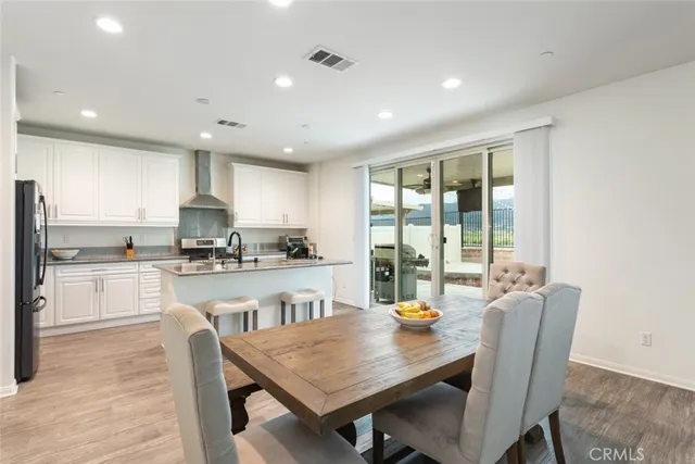 a kitchen with a table chairs microwave and cabinets