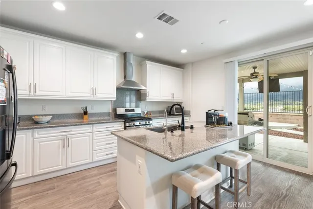 a kitchen with sink a stove and cabinets