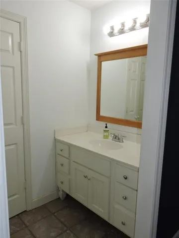 a bathroom with a sink and two mirror