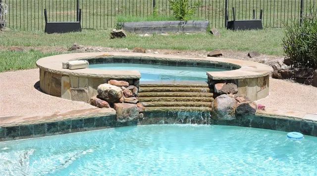 a view of a backyard with plants and outdoor seating