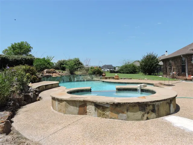 a view of a swimming pool with a yard