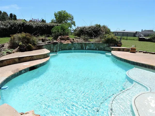a view of a backyard with a garden and slide