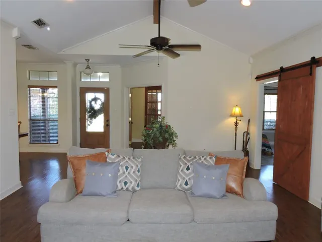 a living room with furniture and a chandelier