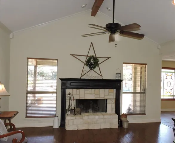 a living room with a fireplace and a window