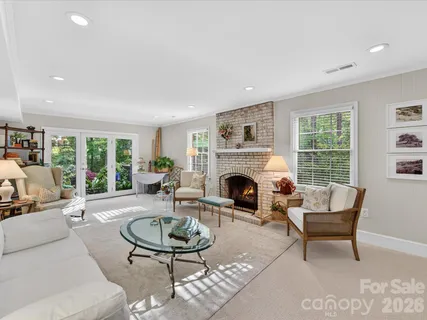 a living room with furniture a fireplace and a table