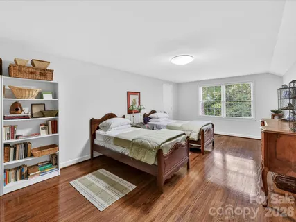 a living room with furniture and a book shelf
