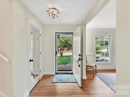 a view of an entryway with wooden floor and a livingroom