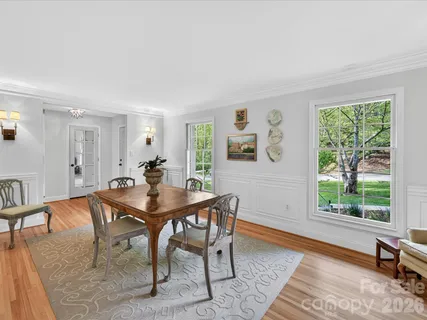 a view of a dining room with furniture and a window