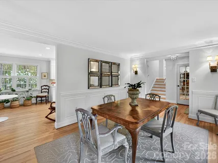 a dining room with furniture and wooden floor