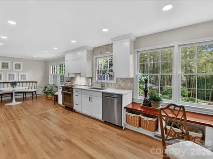 a kitchen with a table chairs stove and cabinets