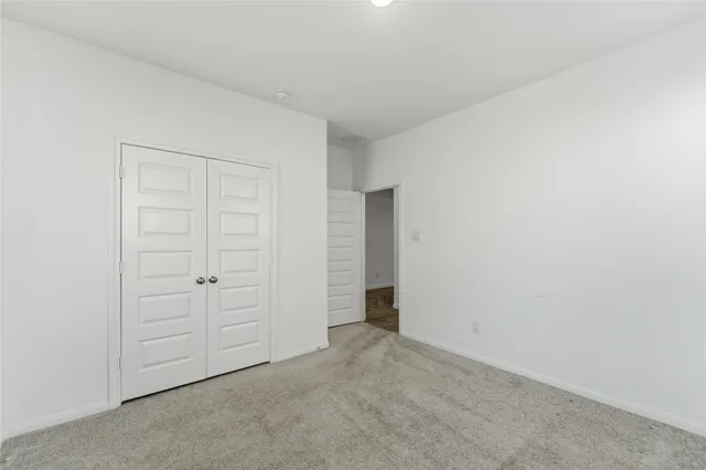 an empty room with closet area
